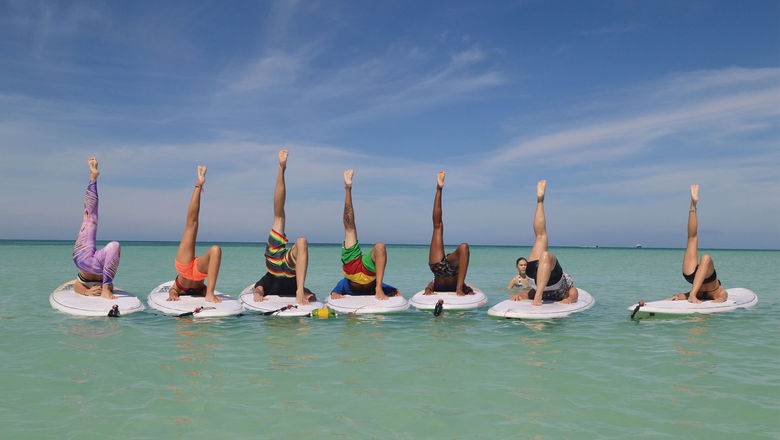 A popular fitness activity offered to guests at the Aruba Marriott Resort & Stellaris Casino is stand-up paddleboard yoga in the waters off Palm Beach.