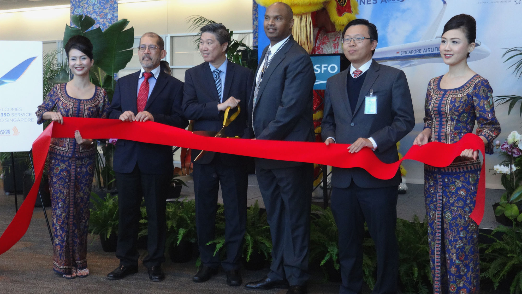 Flanked by flight attendants at the ribbon-cutting of Singapore Airlines' launch of San Francisco service were (from left) Christopher Cheang, Singapore’s counsel general to San Francisco; Sek Eng Lee, Singapore Air’s regional VP of the Americas; Jeff Littlefield, COO of SFO; and Lionel Siau, VP northwest USA for Singapore Air.