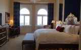 The hotel's rooms feature 14- to 16-foot ceilings, traditional furnishing with dark woods and rich blues and crystal chandeliers over the beds.
