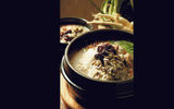 Chicken porridge, or dakjuk, is a Korean dish made with chicken, rice, garlic and green onions.
