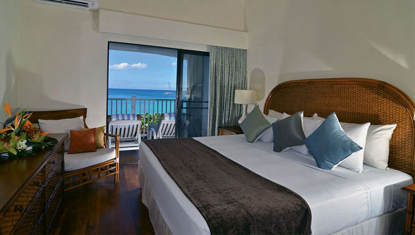 A bedroom in a two-bedroom, oceanview room, which can accommodate up to six people.