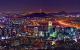 A nighttime view of Seoul with the N Seoul Tower in the distance.