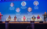 Joanie Ogg, far left, and Mary Pat Sullivan, far right, took to the podiums to moderate the ''What Makes Being a Travel Advisor Awesome'' host-agency panel discussion on Wednesday, featuring, from left: Debbie Fiorino of CruiseOne and Cruises Inc., Jackie Friedman of Nexion, Meredith Hill of Gifted Travel Network, Steve Hirshan of Avoya Travel and Jenn Lee of Travel Planners International.