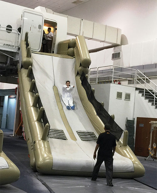 Cabin crew must take a trip down the evacuation slide as part of their safety training.