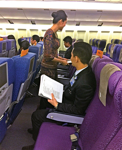 Aspiring Singapore flight attendants do some of their training in a mock aircraft.