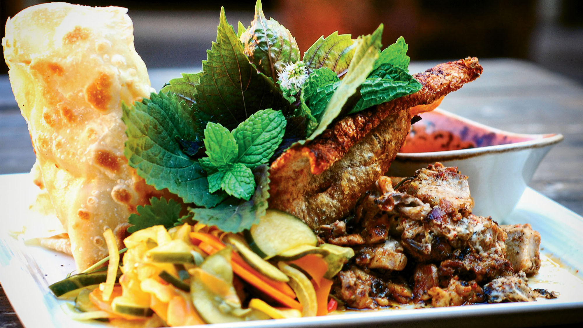 A serving of cochon de lait at Mopho restaurant, where a hog is roasted over open-wood fires.