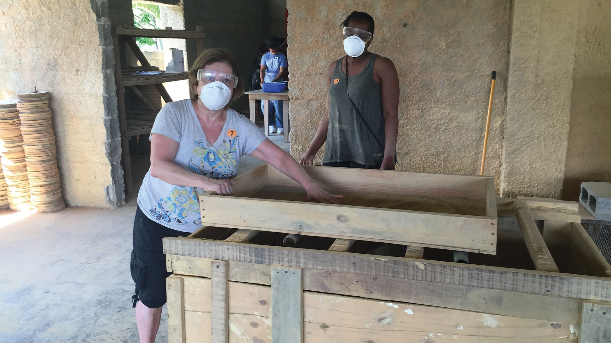 Travel agents Denise Kahoud, front, and Brunilda Borges, shown helping to make water filters, said that her Fathom voyage to the Dominican Republic was "life-changing" but that despite her raves about the cruise, it was a tough sell.