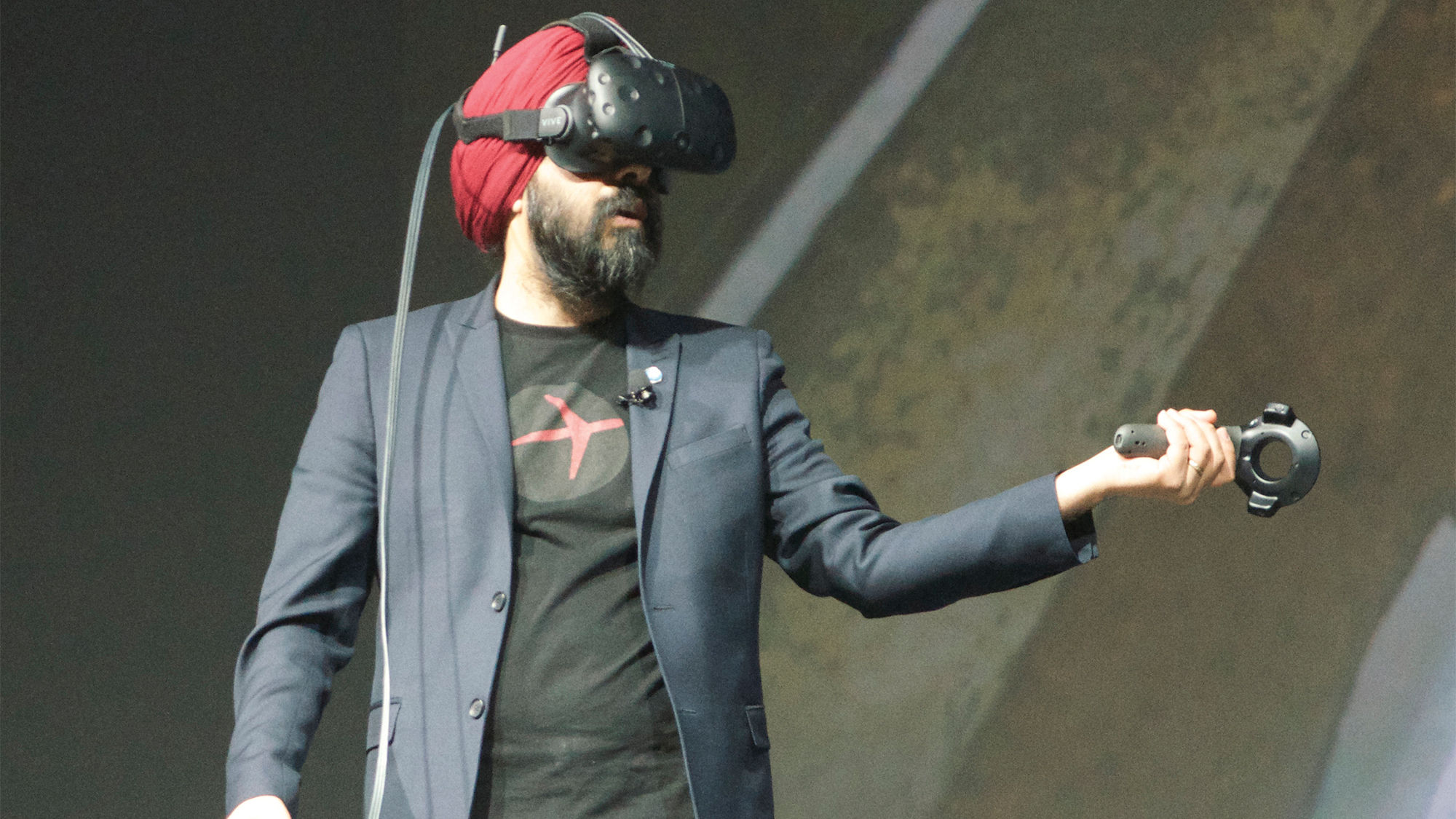 Brand Expedia president Aman Bhutani demonstrating a virtual reality tour of the Space Needle in Seattle at the Expedia Partner Conference.