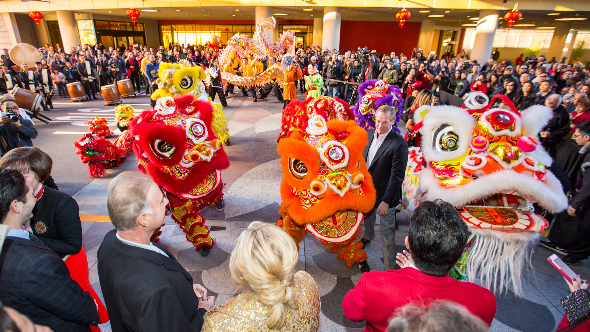 A crowd gathers as a traditional lion dance is performed at the opening.