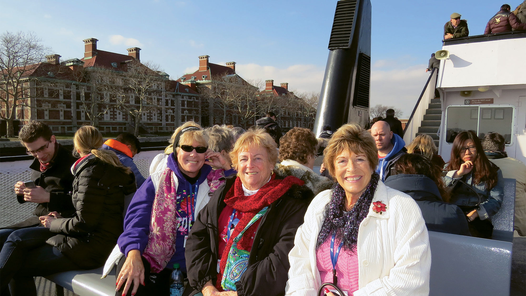 Passengers on a Collette tour ride a ferry to Ellis Island and the Statue of Liberty.
