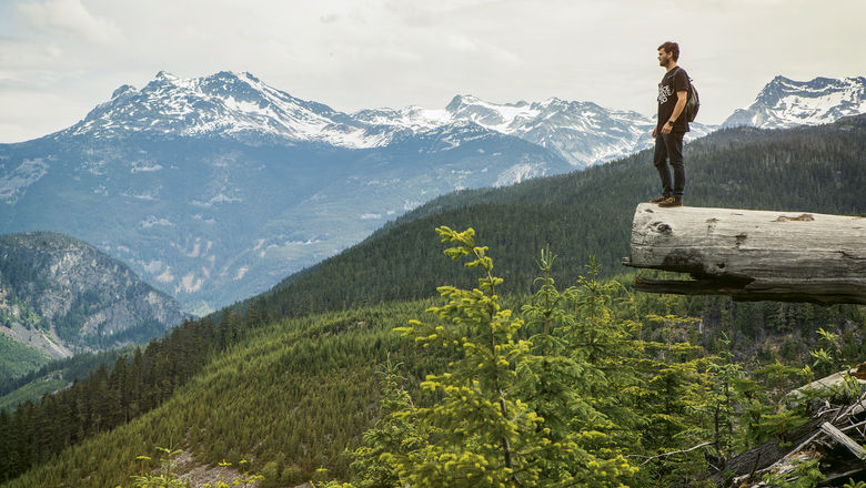 A traveler takes in the Whistler landscape in British Columbia.
