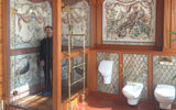 A visitor stands in the wood-trimmed shower stall in Yanukovych's master bathroom. The splashwalls are covered in intricate mosaics and (not shown) the room is lit by a Lalique crystal chandelier.