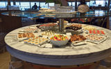 The serving stations in the Colonnade adopt the circular theme prevalent on the Seabourn Encore.