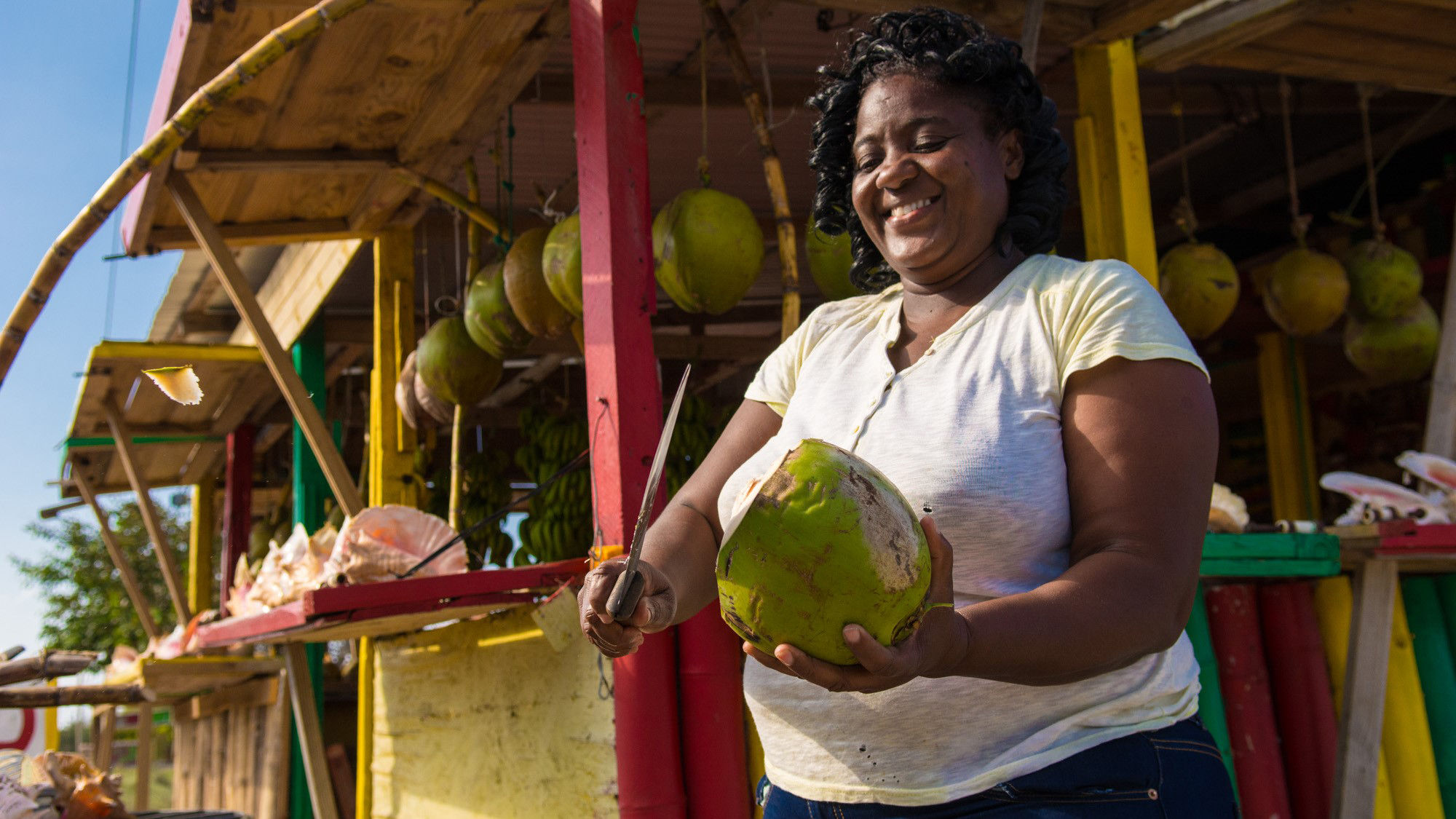 Watching a coconut vendor hack open a coconut is part of Island Routes Caribbean Adventures’ new Mini tour series in Jamaica.