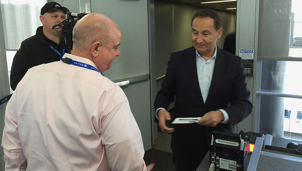 United CEO Oscar Munoz taking tickets for the flight between Chicago and San Francisco.
