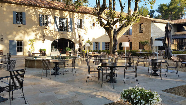 The hotel’s central courtyard includes seating for the Bistrot restaurant. The hotel’s central courtyard includes seating for the Bistrot restaurant.