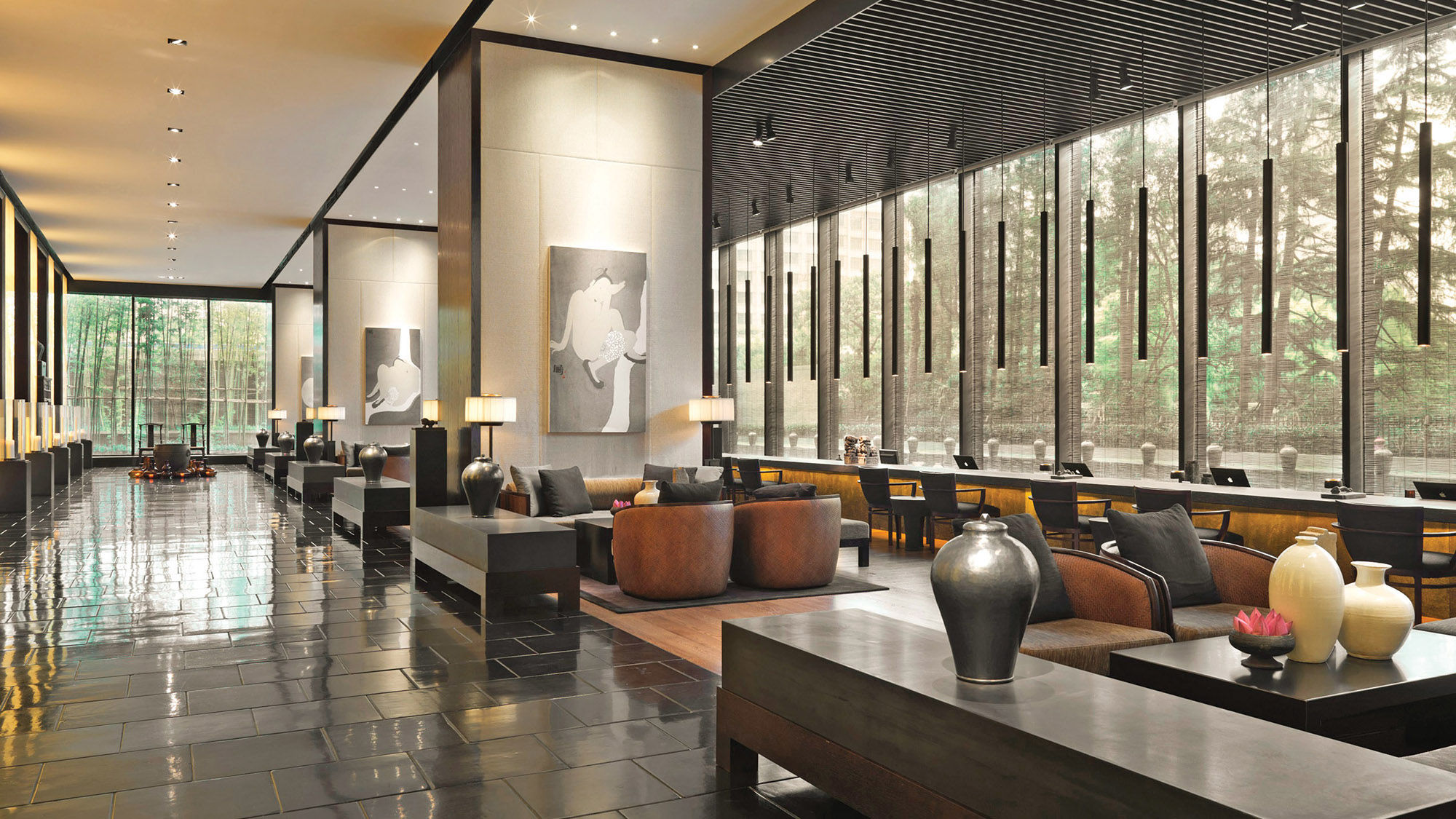 The lobby at Shanghai’s Puli Hotel and Spa features a wall of windows looking out on Jing’an Park.