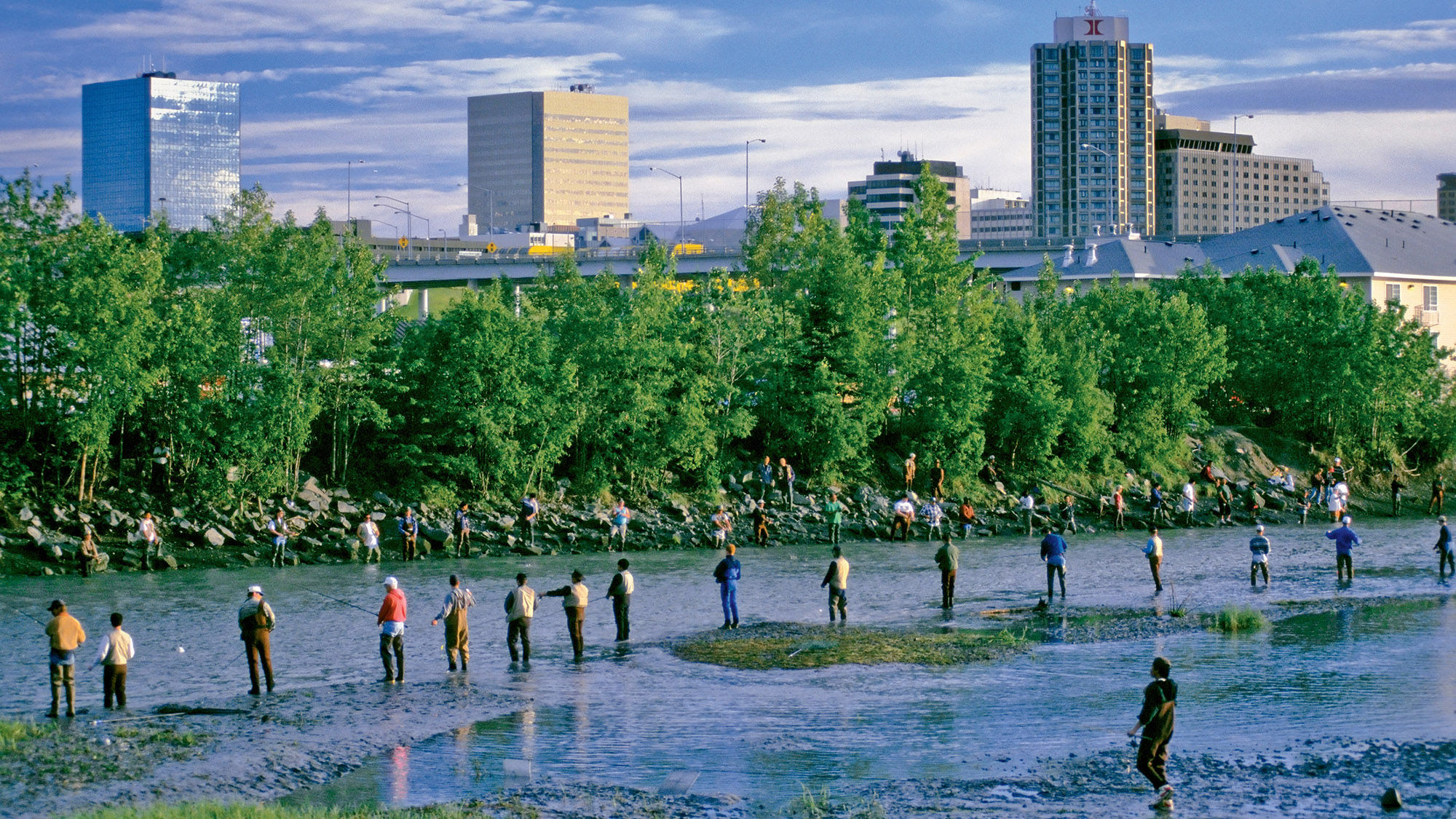 Fishing in Ship Creek in Anchorage. The adjacent Ship Creek Trail begins downtown and is popular for walking tours.