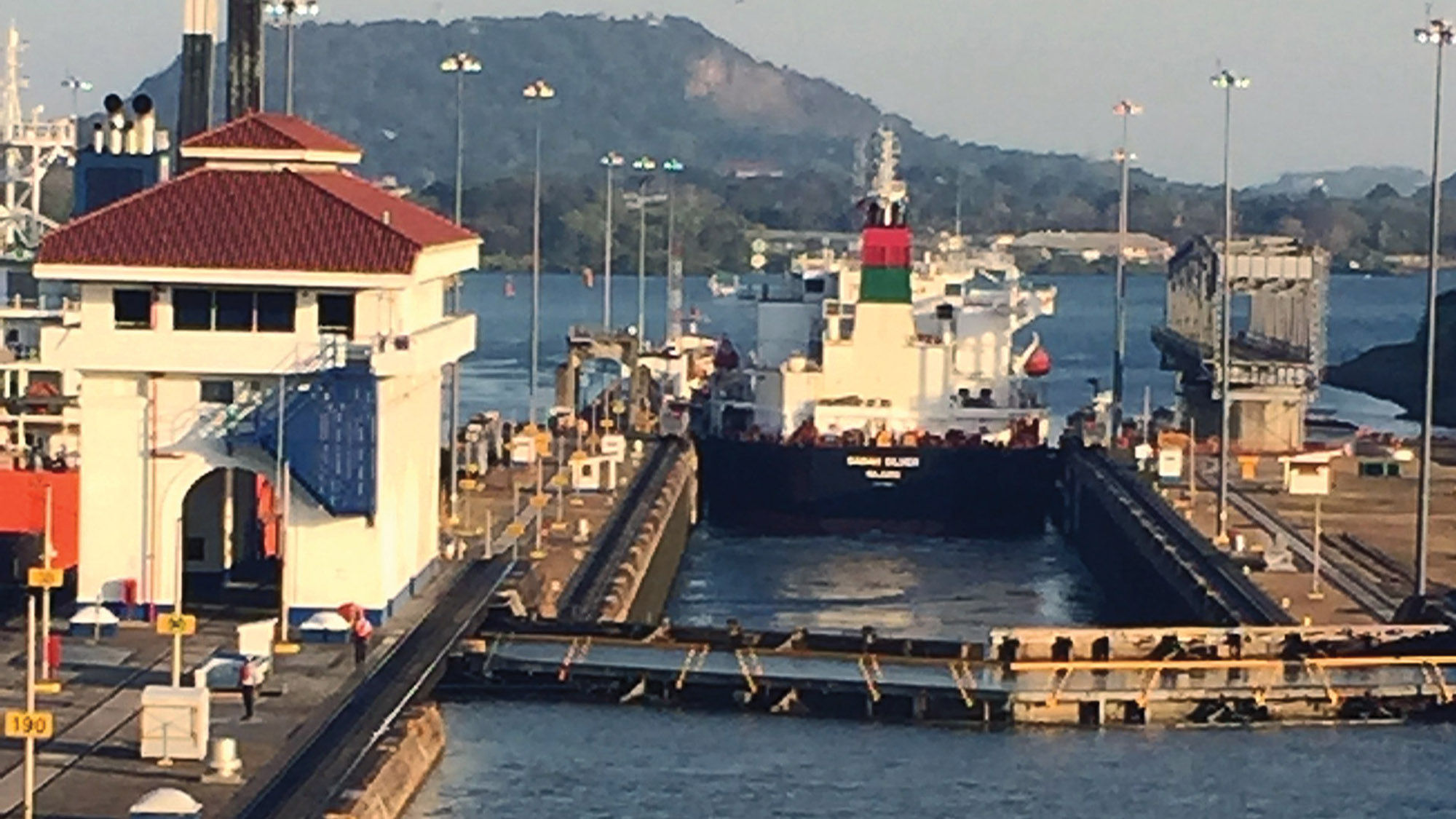 A freighter moves through the Miraflores locks of the Panama Canal ahead of Windstar Cruises’ Star Pride.