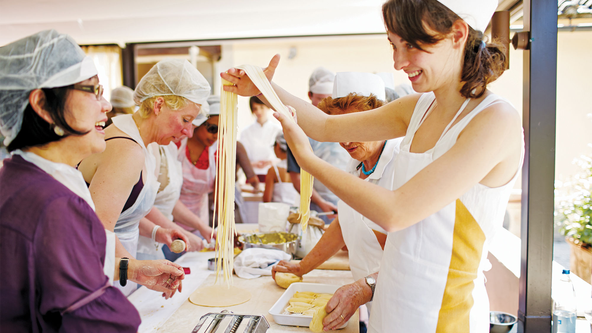 Travelers take a cooking class on a Trafalgar tour in Florence.
