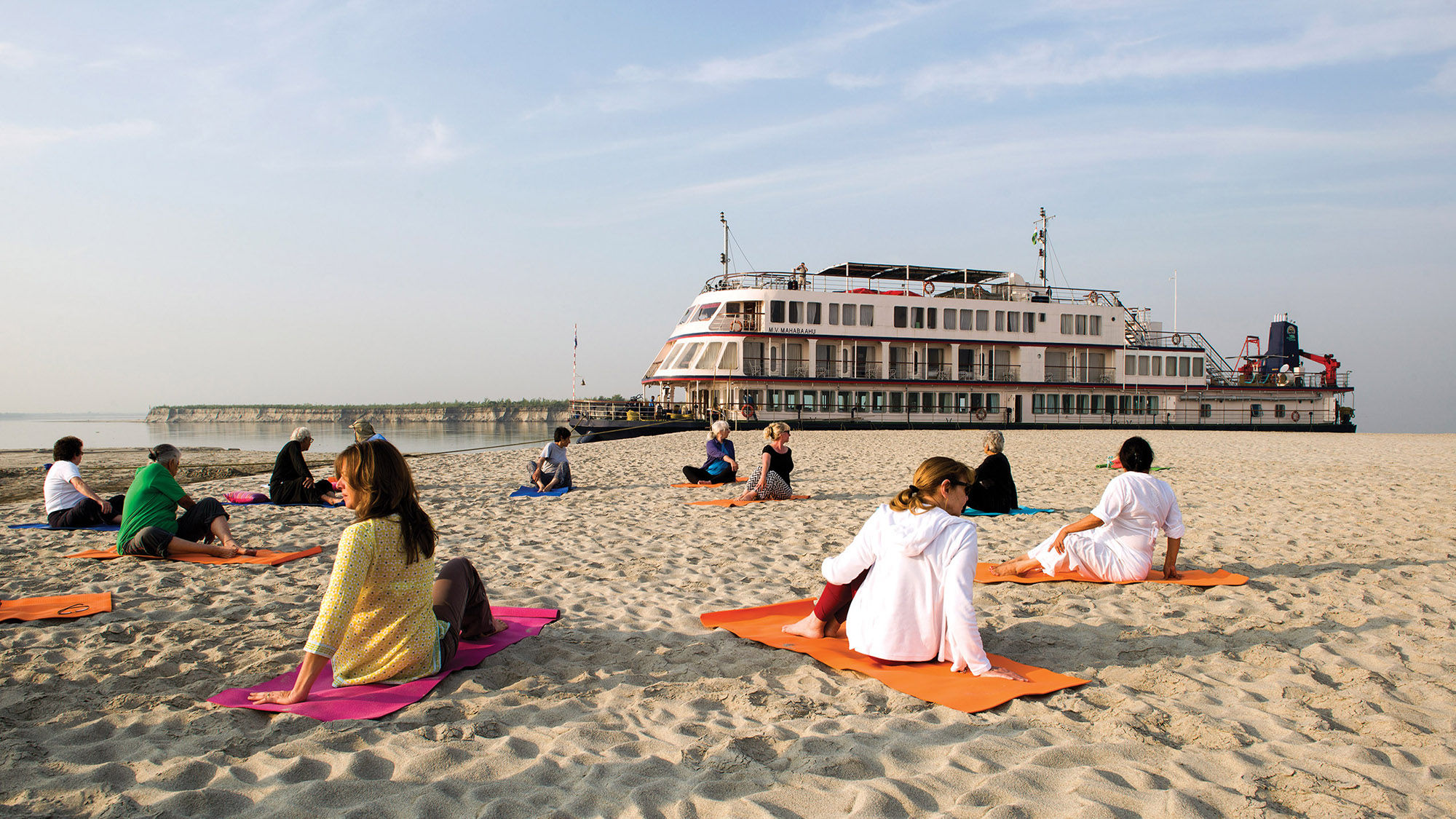 One of the morning yoga classes led by cruise director Neena was held on a Brahmaputra River sandbar. The Mahabaahu is in the background.