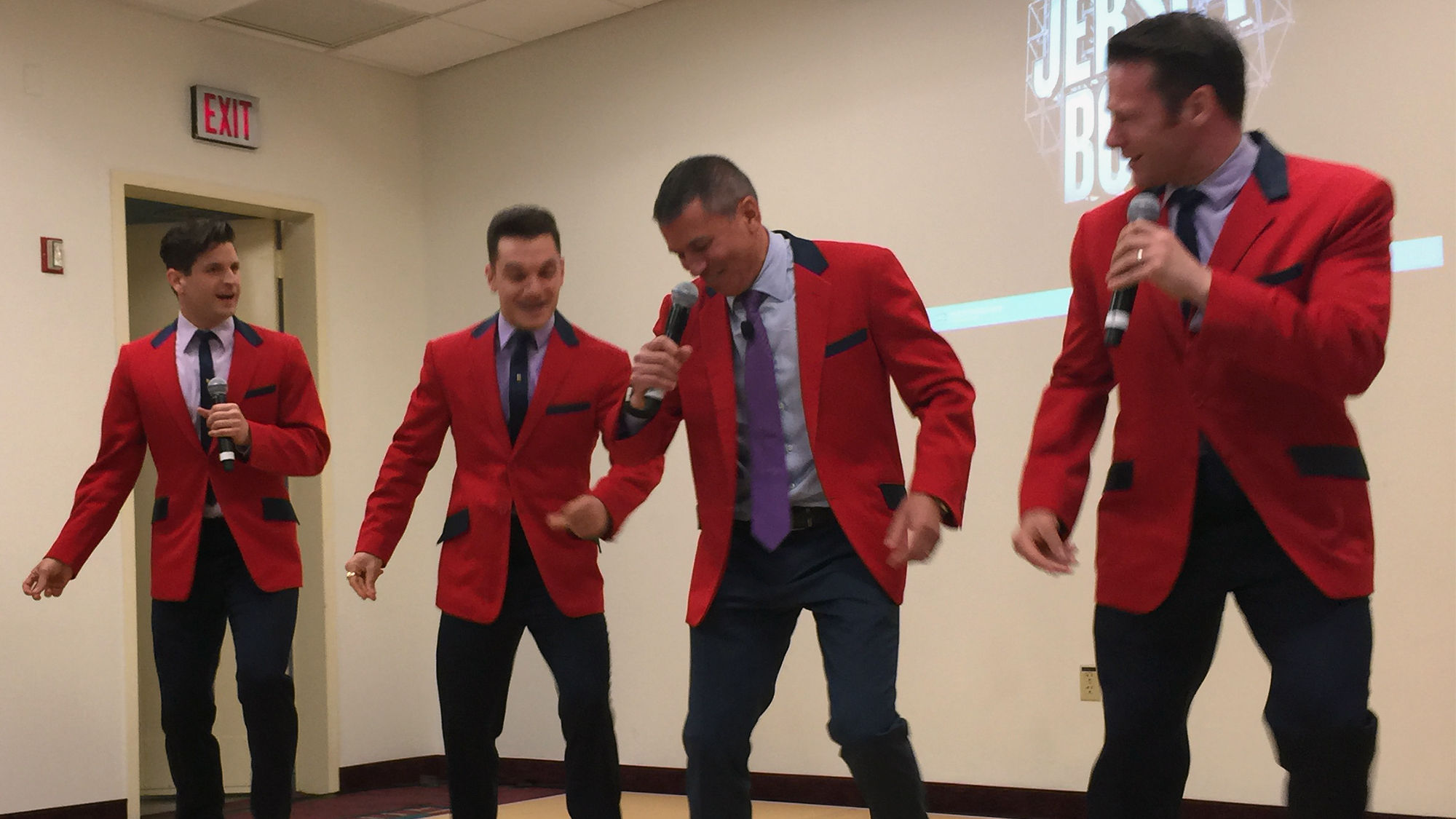 Norwegian Cruise Line CEO Andy Stuart (second from right) dons a red jacket to announce that "Jersey Boys" will be performed on the Norwegian Bliss.