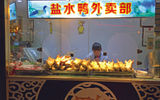 A local meal seems to invariably include duck, the local specialty, in all forms. Here, a street vendor sells salted duck.