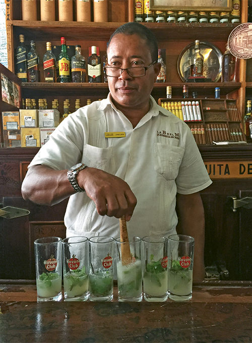 A bartender makes mojitos at El Bodeguita del Medio, a bar that was once a favorite of Ernest Hemingway. A bartender makes mojitos at El Bodeguita del Medio, a bar that was once a favorite of Ernest Hemingway.