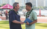 Travel Weekly publisher Bruce Shulman, left, welcomes Classic Vacations CEO David Hu at a beachside reception before the Forum begins.