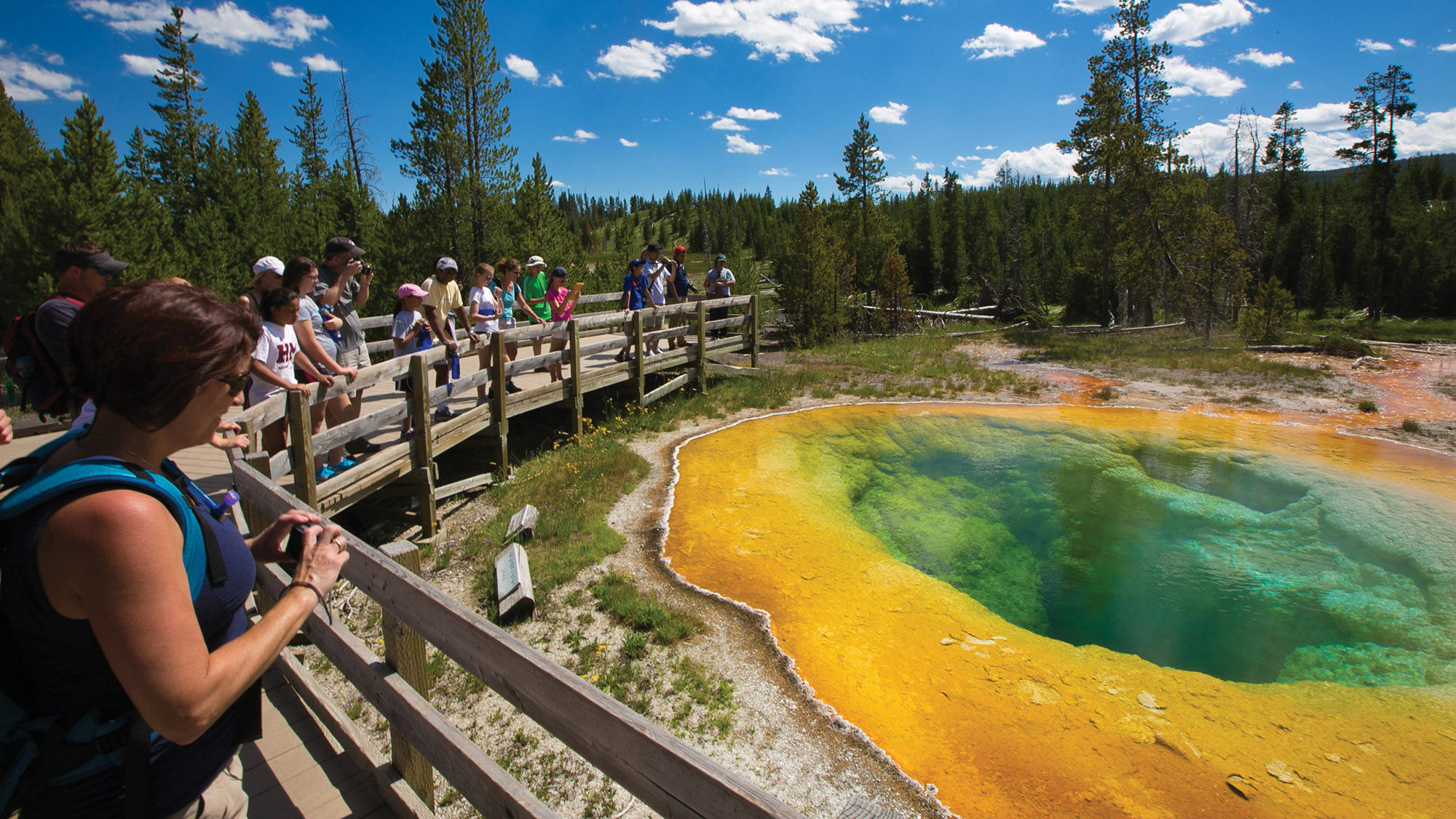Travelers on the boardwalk at Yellowstone National Park. Austin Adventures president Dan Austin said his clients want to visit the national parks as well as have customized, five-star experiences.