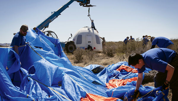 Members of the Blue Origin team recover the crew capsule after its fifth successful flight and soft landing in October. Members of the Blue Origin team recover the crew capsule after its fifth successful flight and soft landing in October.