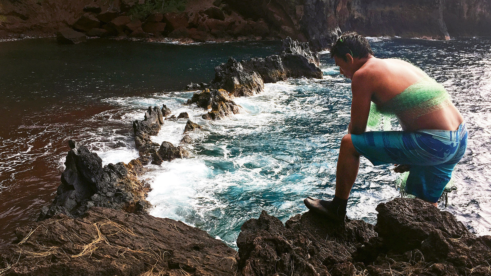 Kini Oliveira scouts the pools along Hana’s beach before casting a throw net to catch fish.