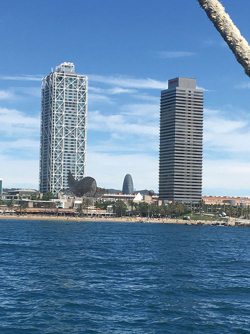 Frank Gehry’s fish sculpture, “Peix,” sits in front of the Mapfre Tower on Barcelona’s waterfront; the tower on the right is the Hotel Arts.