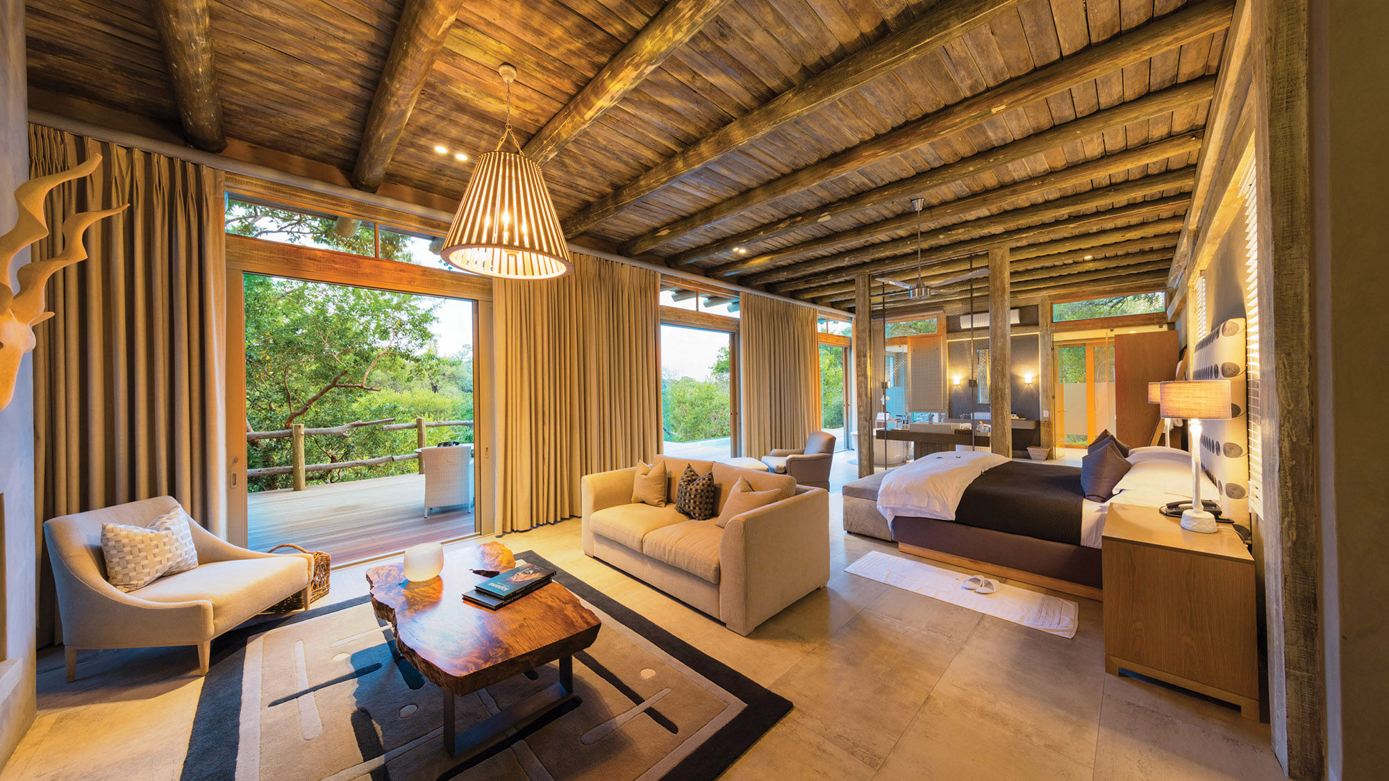 Suites at the Kapama Karula lodge offer unobstructed views of the Klaserie River and amenities such as a stocked minibar and reliable WiFi.