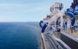 A water thrill ride loops over the side of the ship.