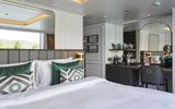 All staterooms feature king-size beds that face toward balconies with panoramic windows, walk-in closets, wall-mounted flat-screen HDTVs, and Nespresso machines.