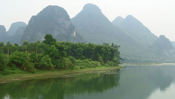 Karst formations emerge from the mist along the Li River near Hangshuo. Karst formations emerge from the mist along the Li River near Hangshuo.