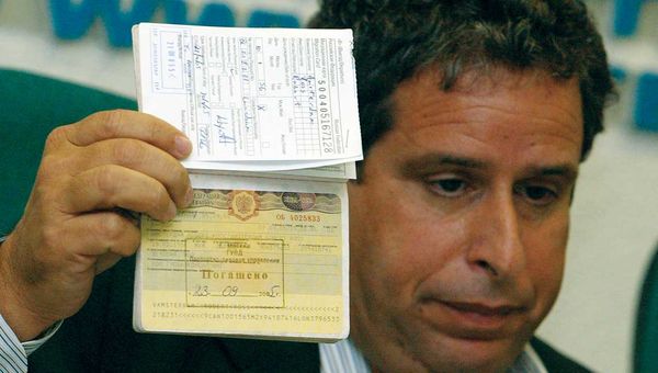 Robert Amsterdam, Canadian attorney for Russian oil tycoon Mikhail Khodorkovsky, shows his passport with his Russian visa annulled at a news conference in Moscow in September 2005. A group of Russian Federal Security Service officers had arrived at Amsterdam’s hotel room in the middle of the night and taken away his passport, he said. When they returned the passport, his Russian visa had been annulled, and he was ordered to leave the country.