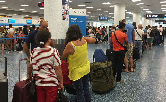 Vacations cut short, Miami travelers head to crowded airport to flee ...