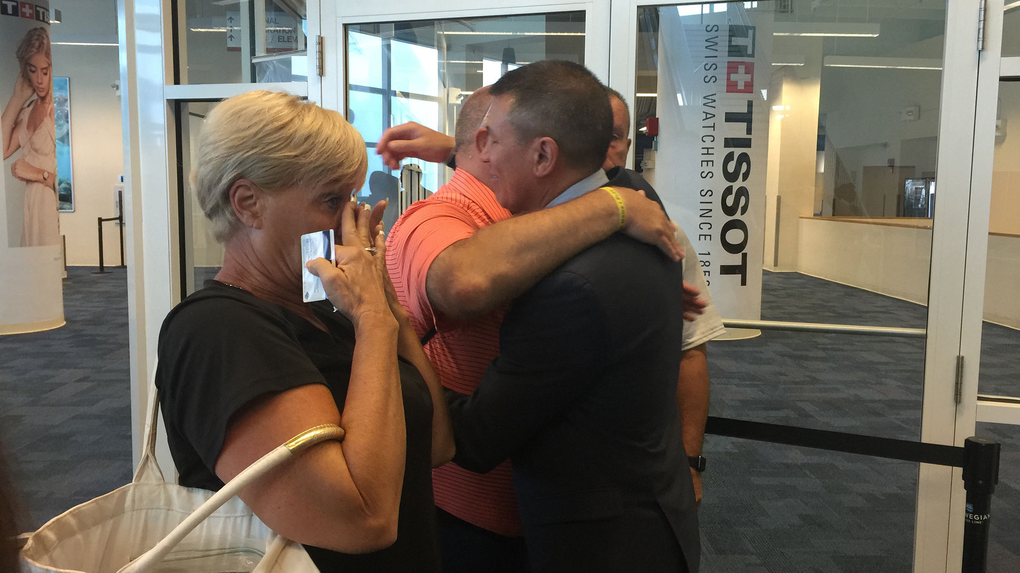 Norwegian Cruise Line CEO Andy Stuart embraces Hurricane Irma evacuee Bryan Denton. At left is Denton's sister-in-law, Jodi.