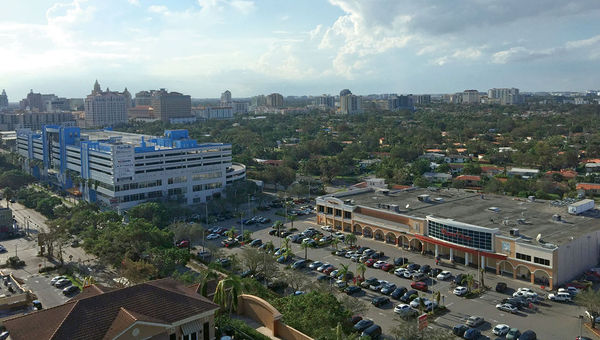 The view days after the storm from the Gables Marquis condo building in Coral Gables, Fla. The Winn-Dixie supermarket on the right reopened and, judging by the parking lot, was busy. The view days after the storm from the Gables Marquis condo building in Coral Gables, Fla. The Winn-Dixie supermarket on the right reopened and, judging by the parking lot, was busy.