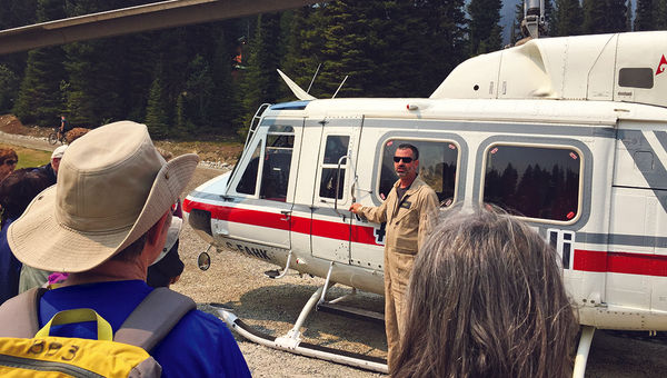 Hikers get a briefing on helicopter protocol and safety from pilot Matt Ellis before the first ride. Hikers get a briefing on helicopter protocol and safety from pilot Matt Ellis before the first ride.
