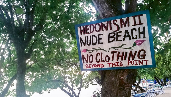 A nude beach sign lets guests know what’s in store beyond that point at Hedonism II.