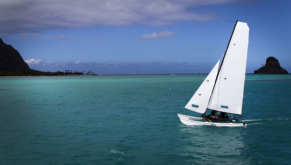 A boat sails past Mokolii, the island also known as Chinaman's Hat, during a Kualoa Ranch catamaran boat. A boat sails past Mokolii, the island also known as Chinaman's Hat, during a Kualoa Ranch catamaran boat.