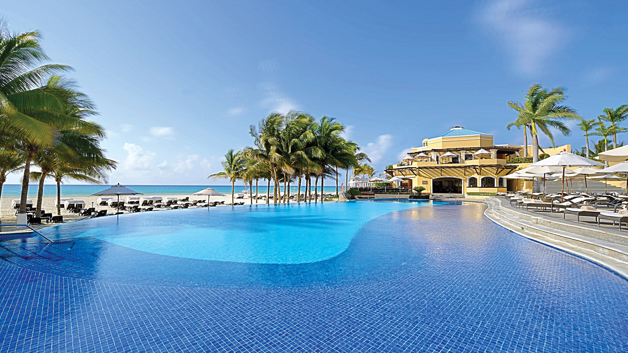 Guests can enjoy poolside massages at the adults-only resort in the Playacar enclave.