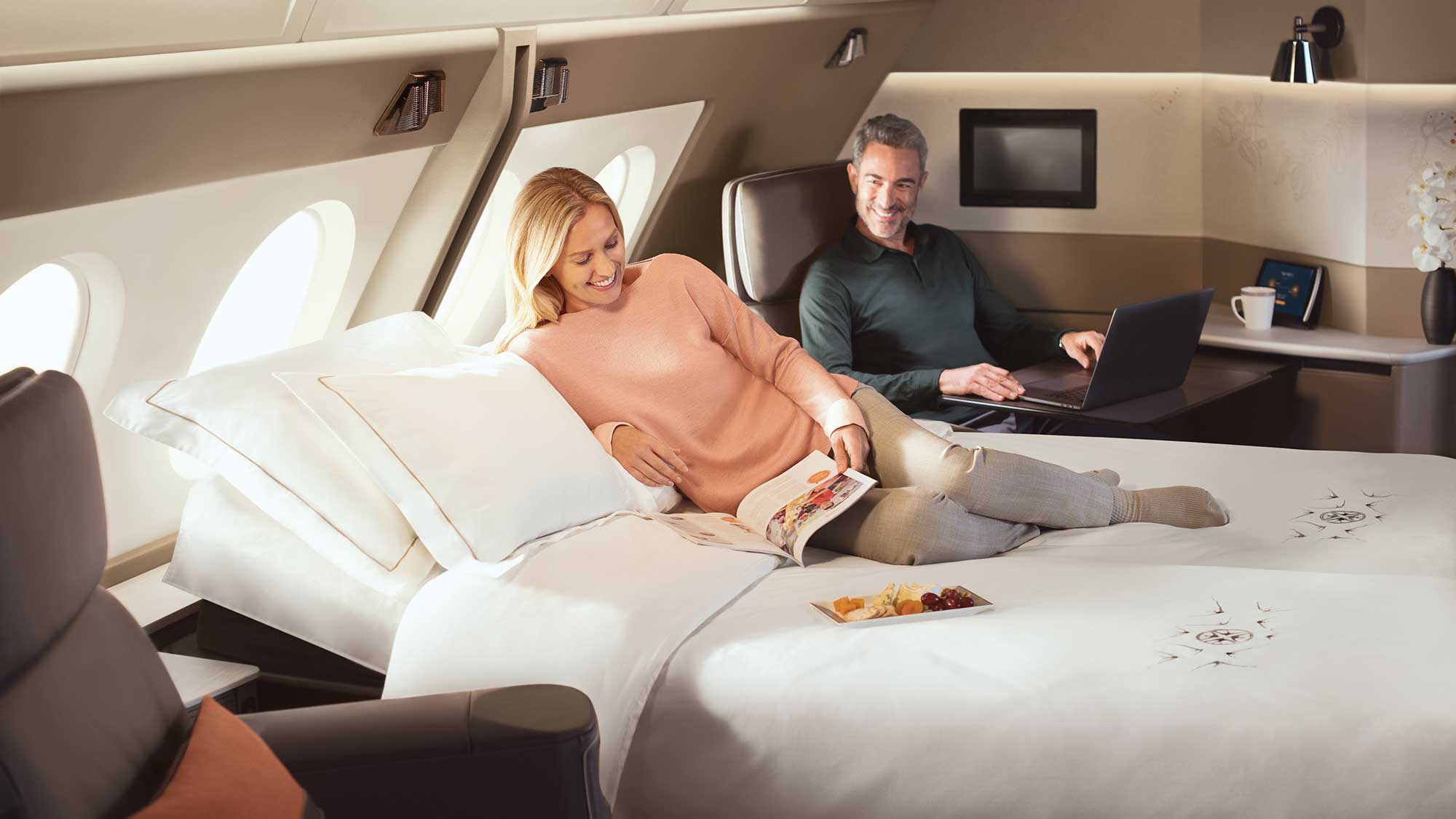 Couples flying together can remove a central partition to turn two suites into one.