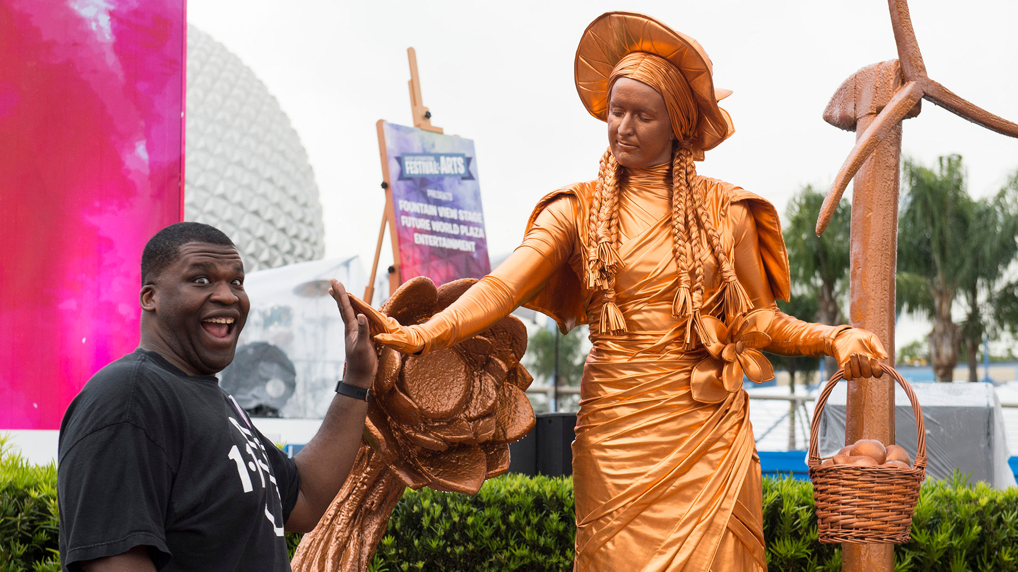 A guest interacts with one of the Epcot Living Statues during the Epcot International Festival of the Arts at Walt Disney World Resort.