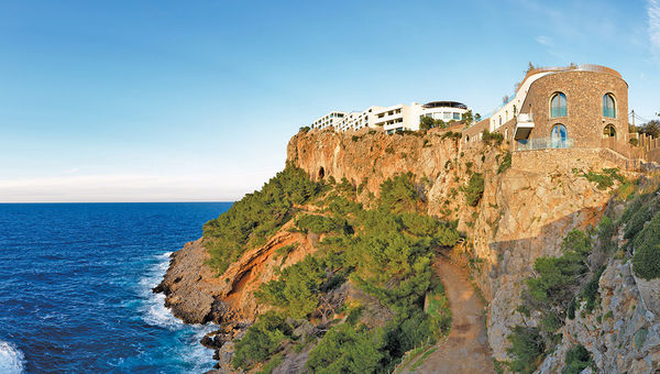 The Jumeirah Port Soller Hotel & Spa, built on a cliff in Mallorca, offers stunning views of the Mediterranean and the island’s rugged terrain. The Jumeirah Port Soller Hotel & Spa, built on a cliff in Mallorca, offers stunning views of the Mediterranean and the island’s rugged terrain.