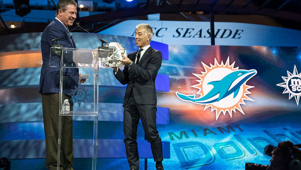 Dan Marino gives a Miami Dolphins helmet to MSC Cruises USA President Roberto Fusaro. Dan Marino gives a Miami Dolphins helmet to MSC Cruises USA President Roberto Fusaro.