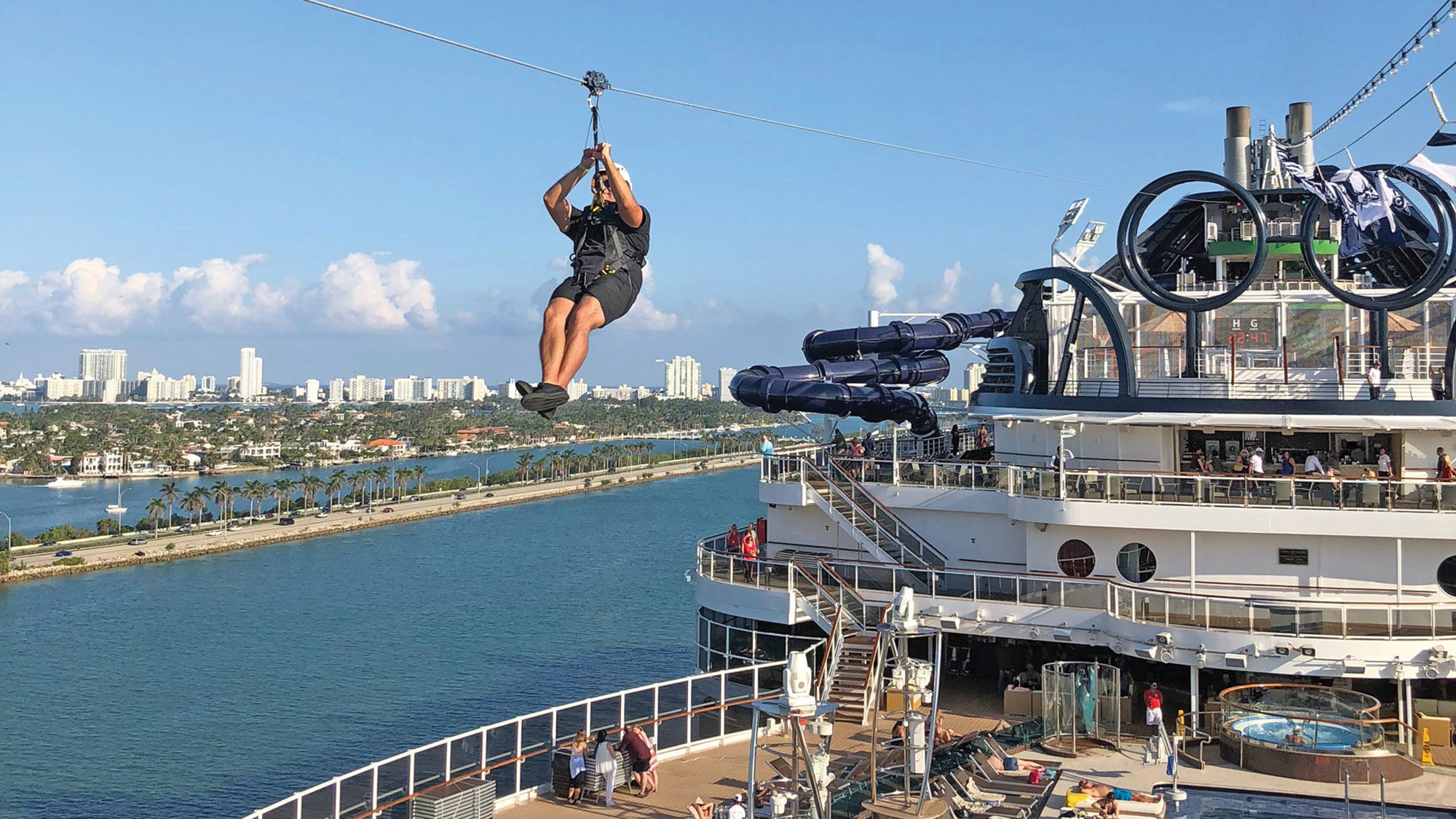 A zipline rider soars 20 decks above the ocean.